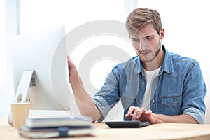 Business man typing on the keyboard of a personal computer.