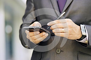 Business Man Typing With Pen On Phablet Smartphone