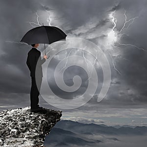 Business Man with umbrella look rainstorm cloud