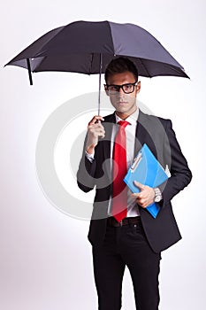 Business man with umbrella and notepad