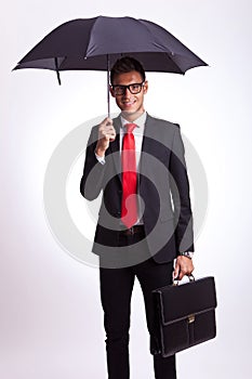 Business man with umbrella and suitcase