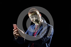 Business man under the mask disguise being Anonymous and implying that he is a hacker or anarchist