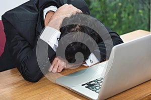 Business man unhappy head down on laptop computer