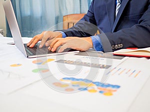 Business man use laptop analyzed the chart, set targets for new management success