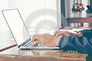 Business man use white screen laptop on wood table.