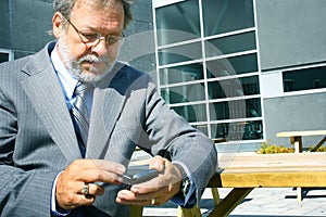 Business man using blackberry