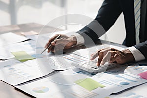 Business man using a calculator to calculate numbers on a company