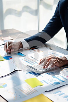 Business man using a calculator to calculate numbers on a company