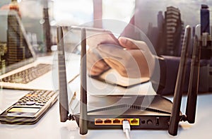 With business man using a computer in home office background . Computers and Router wireless broadband Accessories concept photo