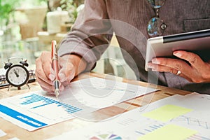 Business man Using digital tablet with Report chart outdoor Cafe