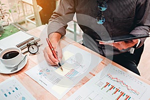 Business man Using digital tablet with Report chart outdoor Cafe