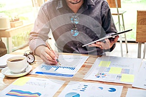 Business man Using digital tablet with Report chart outdoor Cafe