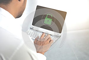 Business man is using the laptop with unlocked key icon for data protection and access authorized concept