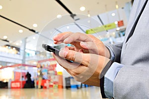 Business Man using Mobile Phone in Modern Shopping Mall