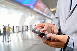 Business Man using Mobile Phone in Modern Train Station