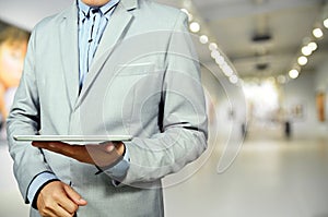 Business Man using Mobile Tablet in Gallery Art Center or Museum