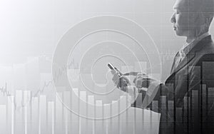 Business man using smartphone with abstract financial chart and up trend line graph in stock market on black and whit color backgr