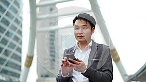 Business man using smartphone in city