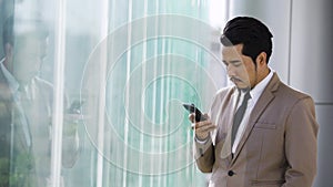 Business man using a smartphone in office