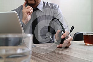 business man using VOIP headset with digital tablet computer doc