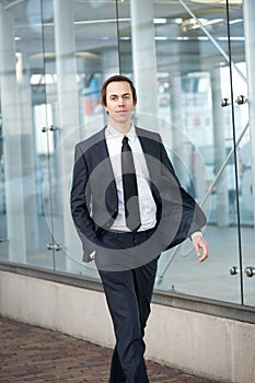 Business man walking on sidewalk in the city