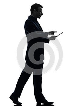 Business man walking touchscreen digital tablet silhouette