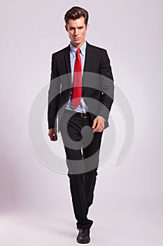 Business man walking towards you