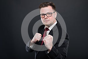 Business man wearing black suit holding fists like fighting photo