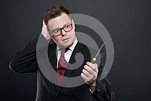 Business man wearing black suit holding screwdriver