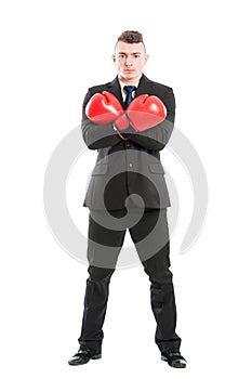 Business man wearing boxing gloves and arms crossed