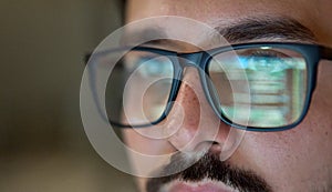 Business man wearing glasses with reflection using computer developing code.