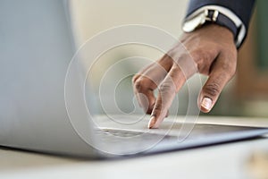 Business man wearing suit typing finger using laptop computer. Close up