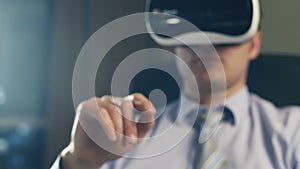 Business man wearing virtual reality googles / VR Glasses to work with in modern office