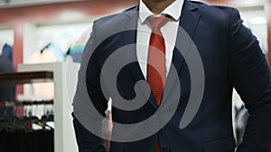 Business man in white shirt buttoning his suit jacket