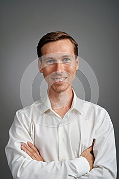 Business man in white shirt, portrait on grey background.