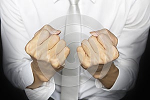 business man in white work clothes ,clenched fists to encourage work.,Build confidence in doing business