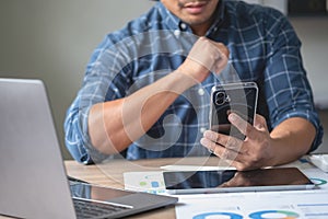 A business man who is using two mobile phones to communicate with customers is difficult. The concept is busy