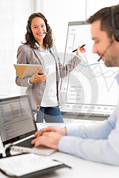 Business man and woman analysing stats while doing video conference