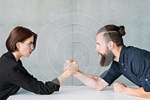 Business man woman arm wrestling competition