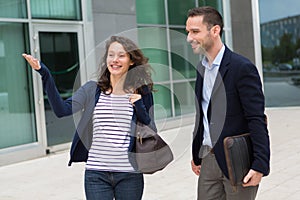 Business man and woman chatting together after work