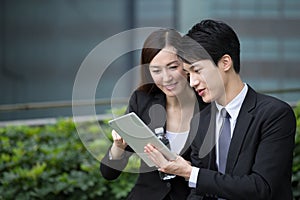 Business man and woman discuss financial plan on digit