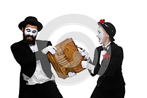 Business man and woman fighting over briefcase