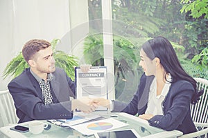 Business man and woman meeting and showing success with handshake