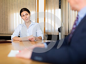 Business man and woman in office filling up documents