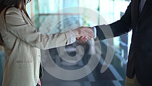 A business man and woman shaking hands