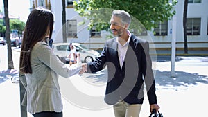 A business man and woman shaking hands