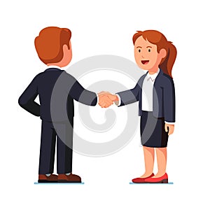Business man and woman shaking hands firmly