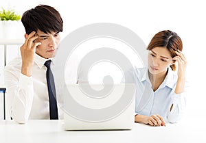 Business man and woman solving problem in office