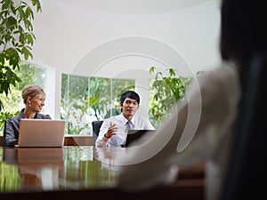 Business man and woman talking in meeting room