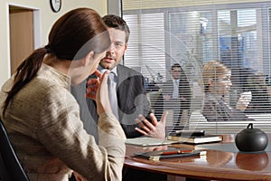 Business man and woman talking in the office